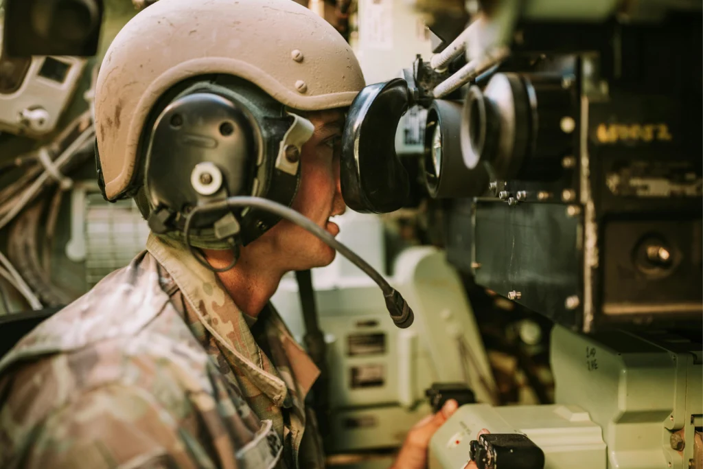 Operator in a military vehicle wearing a headset